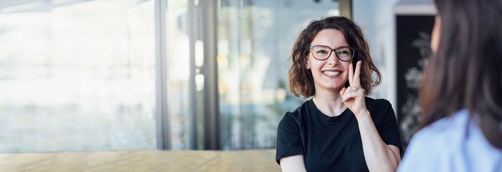 Młoda kobieta używa języka migowego