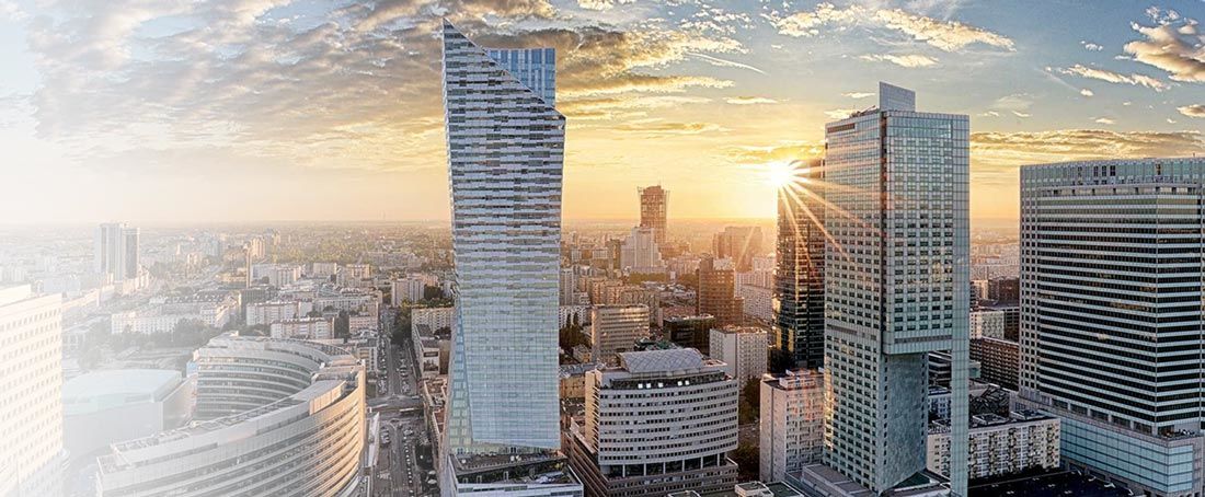 wieżowce biurowe na tle zachodzącego słońca