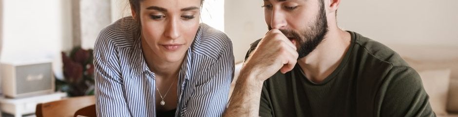 młoda para przed laptopem, przeglądająca oferty konsolidacji kredytów